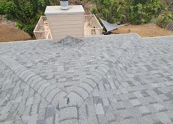Gray architectural shingles installed in herringbone pattern on residential roof