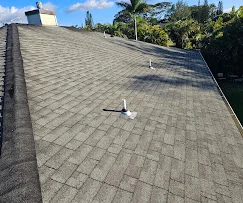 Gray asphalt shingle roof with proper ventilation and flashing installation