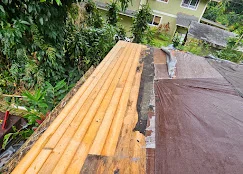 New asphalt shingles and plywood decking installed on residential roof during replacement project