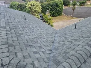 Gray dimensional asphalt shingles installed on residential roof with proper overlap and alignment