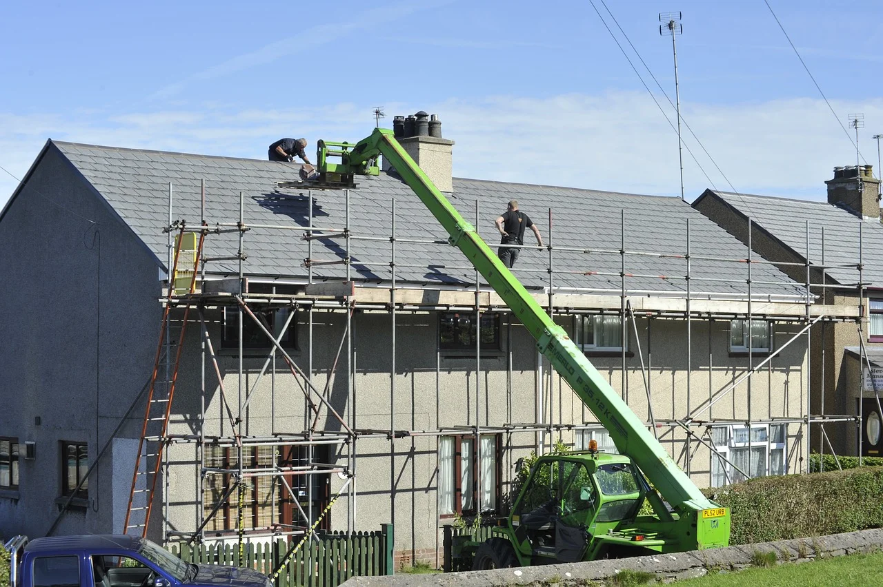 Residential roof replacement with slate shingles, scaffolding, and elevated work platform