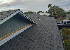 New asphalt shingle roof with charcoal gray dimensional shingles and gable vent flashing