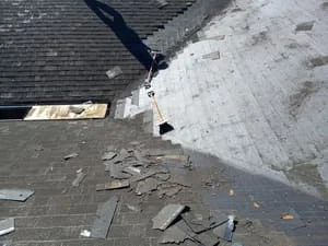 Asphalt shingle roof tear-off with debris removal and new underlayment installation
