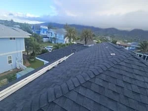Charcoal gray asphalt shingle roof with architectural shingles and metal flashing installed on residential home