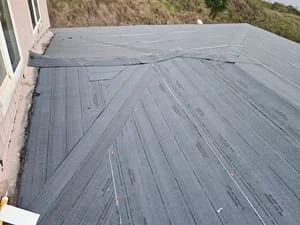 Newly installed asphalt shingles in herringbone pattern on residential roof