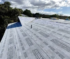 White TPO membrane flat roof installation with reinforced seams and systematic panel layout