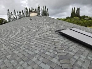Gray asphalt shingles installed on pitched roof with clean lines and proper alignment