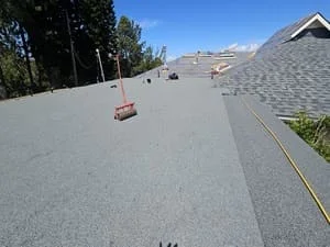 Gray asphalt shingle roof installation with aligned courses and proper edge detailing