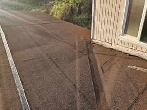 Newly installed asphalt shingles on residential roof with clean lines and proper fastening