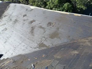 Asphalt shingles and underlayment installed on sloped roof deck during installation