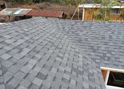 Gray dimensional asphalt shingles installed in staggered pattern on residential roof
