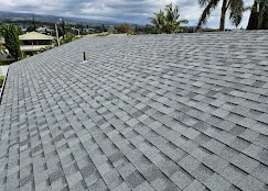 Gray architectural shingles installed on residential roof with dimensional layering and clean alignment