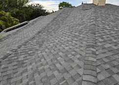 Charcoal gray architectural shingles installed on pitched residential roof with clean lines and valleys